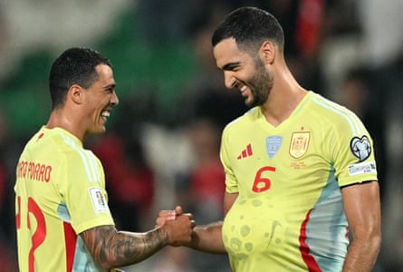 Spain’s Mikel Merino tucks the match ball under his shirt as he enjoys the 6-0 victory with teammate Pedro Porro