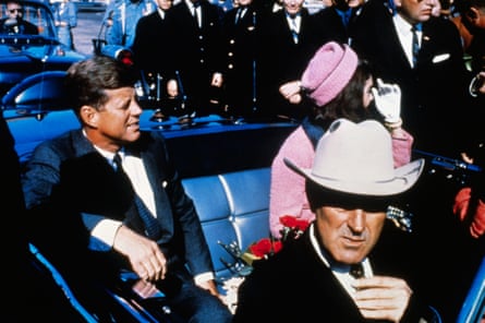 John F Kennedy and Jacqueline Kennedy ride in a motorcade from the Dallas airport into the city.