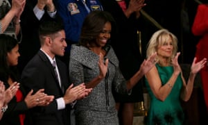 First lady Michelle Obama, centre, applauds during the 2015 State of the Union address. This time a seat in her guest box will be left empty to represent the victims of gun violence.