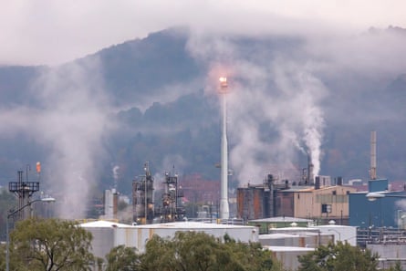 smoke rises from white buildings
