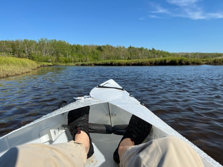 man inside kayak on water during a sunny day