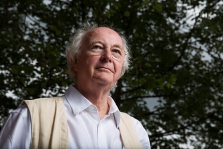 A man poses below a tree