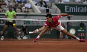 Novak Djokovic stretches to return the ball to Rafael Nadal.