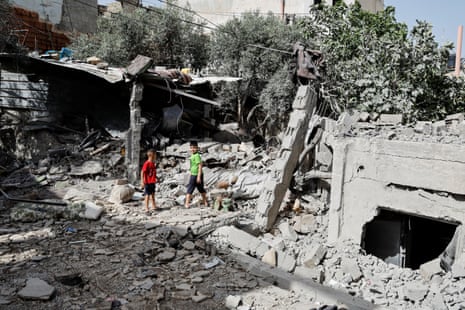 Palestinian boys walk near a damaged building in Jenin on Saturday.