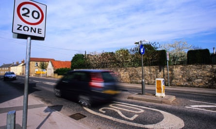 Car passing a 20mph speed limit sign
