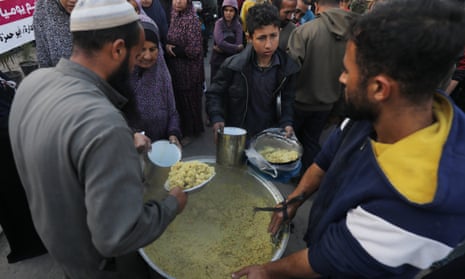Displaced Palestinians collect food