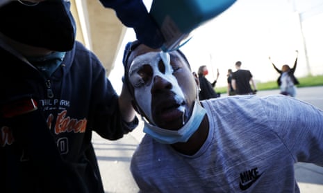 A protester is doused with milk in Minneapolis