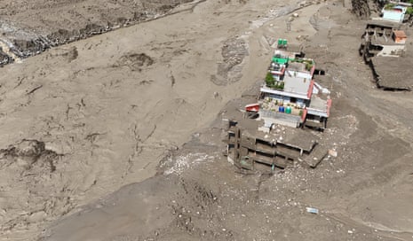An aerial view shows buildings and infrastructure damaged along the swollen Trishuli River following a massive flash flood triggered by an avalanche of ice and rock in the upper Lhende River on the Tibetan side.