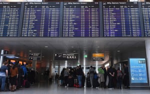 Passengers wait in line at counters of the German airline Lufthansa at the Franz-Josef-Strauss airport in Munich, southern Germany,.