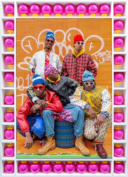 Very brightly coloured photograph on men in very colourful closing against a yellow backdrop