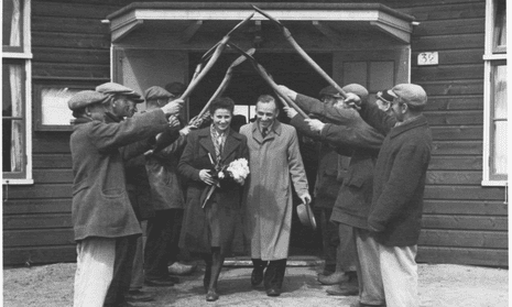 Westerbork newlyweds Ingeborg Koh and David Reichmann emerge into an improvised shovel arch on 1 May 1942. Photograph: Image bank W02