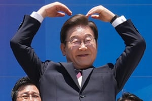 a man in a suit with his arms over his head