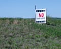 A sign in a field of grass reads 'No Data Center'