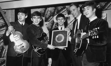 The Beatles collecting a silver award.