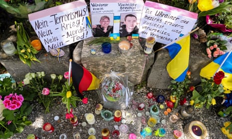 Flowers and candles in front of photos of the two killed Ukrainian soldiers