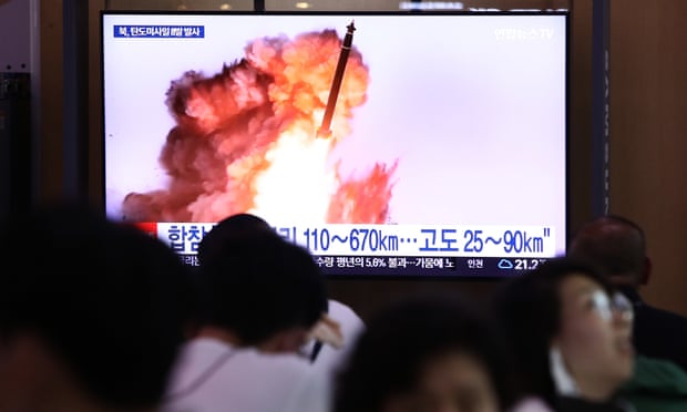 People in South Korea watch a television broadcast showing the launch of a North Korean missile on Sunday