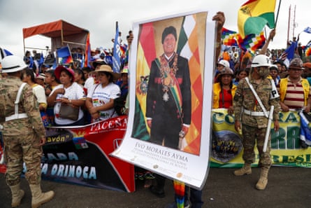 A supporter holds a poster of Morales during a rally to welcome him to Chimoré on 11 November.