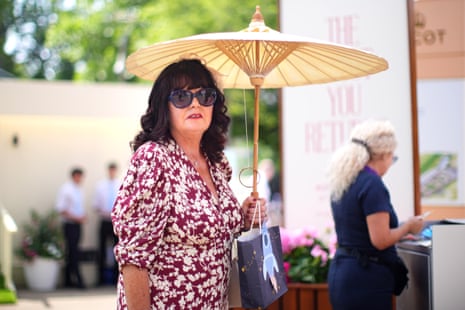 A racegoer with a parasol during day five of Royal Ascot.