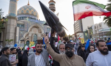 Demonstrators in Tehran carry a model of Iran's first-ever hypersonic missile, Fattah, past a mosque.