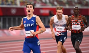 Jakob Ingebrigtsen of Norway celebrates crossing the finish line to win gold ahead of silver medallist; Timothy Cheruiyot of Kenya and bronze medallist; Josh Kerr of Britain.