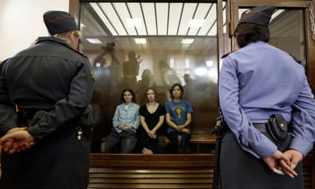 Pussy Riot members, from left, Yekaterina Samutsevich, Maria Alyokhina and Nadya Tolokonnikova behind glass in a court room in Moscow, Russia on 2 September 2012.