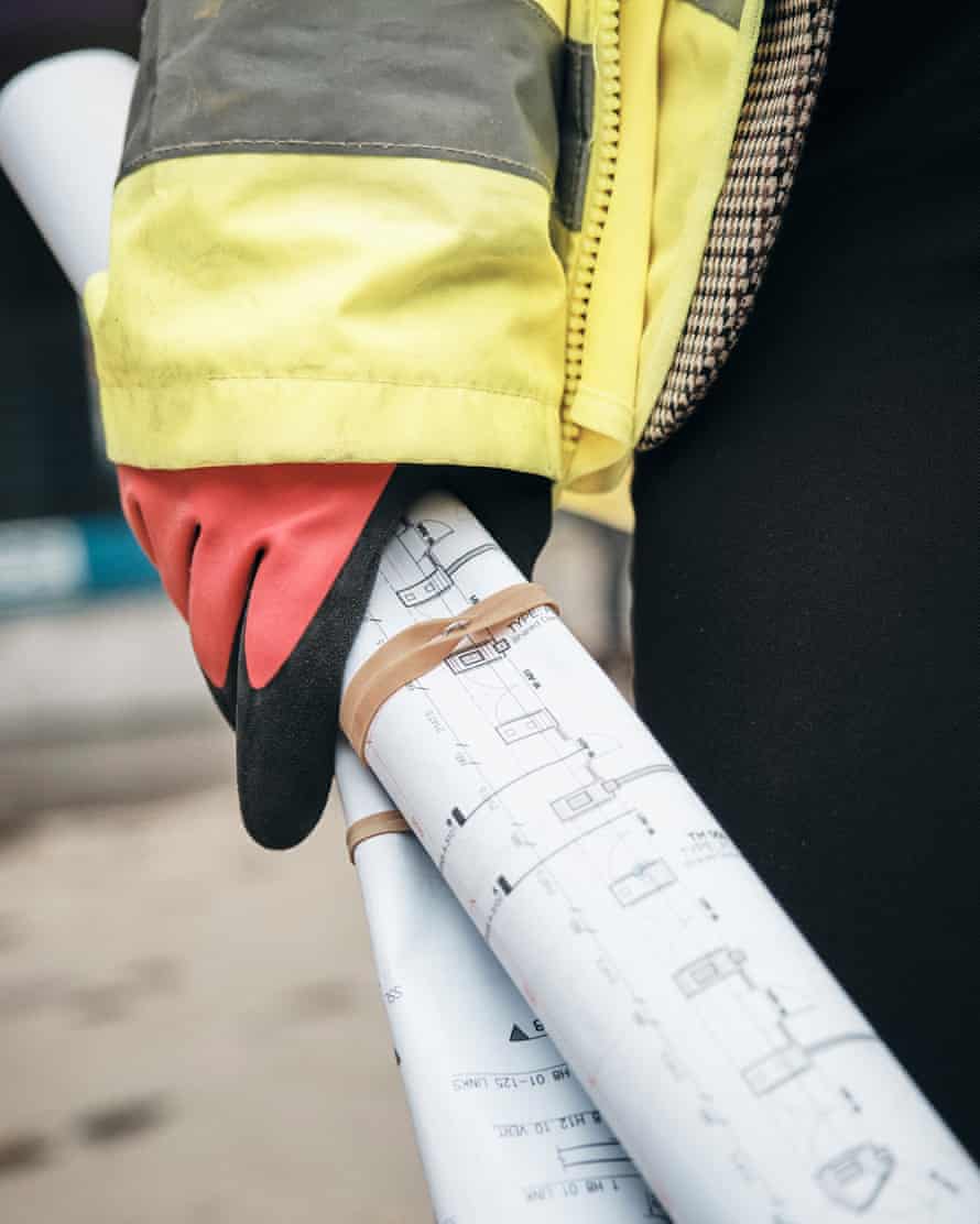 Nikki Davison, quantity surveyor, holding building plans