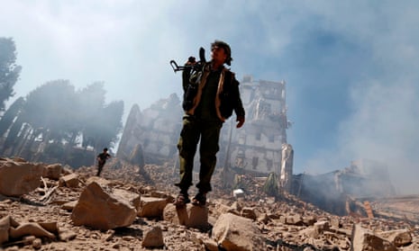 Houthi fighters at the site of a Saudi-led coalition airstrike in Sana’a, Yemen, on 5 December.