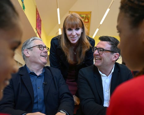 Keir Starmer, former deputy prime minister Angela Rayner and Greater Manchester mayor Andy Burnham meet pupils at Holy Trinity primary school in Ashton, Greater Manchester, 13 April 2026.