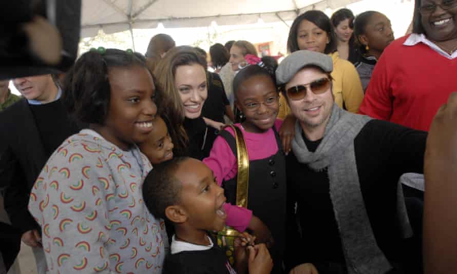 Angelina Jolie and Brad Pitt pose for photographs with children affected by Hurricane Katrina in New Orleans, on 22 December 2007.