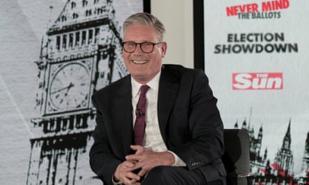 Keir Starmer smiling in his seat