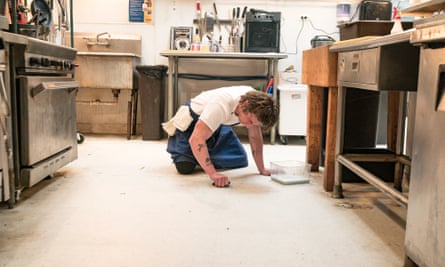 Jeremy Allen White as Carmen 'Carmy' Berzatto scrubs the kitchen floor in a scene from The Bear