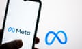 A person's hand holds a phone showing the Meta logo