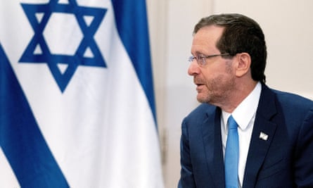 Israel’s President Isaac Herzog is pictured in front of an Israeli flag.