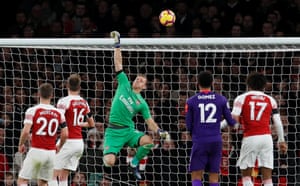 Bernd Leno palms Virgil van Dijk’s header over the bar.