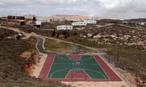 A basketball court and houses in the illegal outpost of Amona, north of Ramallah.