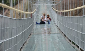 A group of friends take a selfie mid-way across the bridge. Constructed with super strong glass, each pane is 24 millimetres thick and 25 times stronger than average.