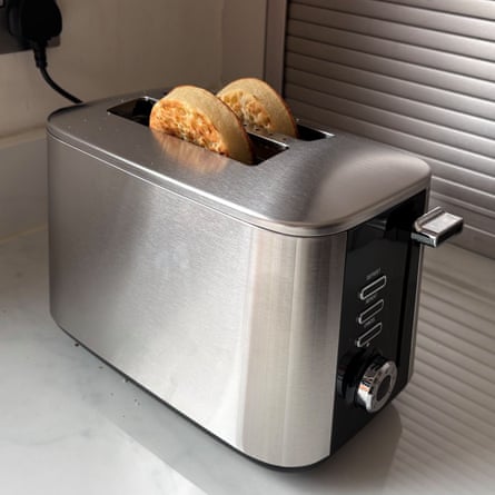A silver and black Lakeland Rapid Toaster with two crumpets peeping out the top on a worktop