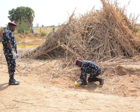 Police anti-bomb squad officers inspect the site of a US airstrike in Jabo, Nigeria, on Friday.