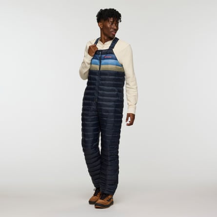 A model wearing a pair of Cotopaxi down overalls