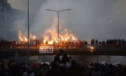 Protesters wave flares during a Belgrade demonstration against the government-backed proposal for a lithium mine.