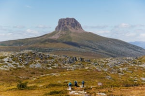 Hikers walking towards Barn Bluff on the overland track in Cradle Mountain Lake St Clair National Park, part of Tasmanian Wilderness, UNESCO World Heritage Site