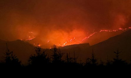 Wildfire on hills at night