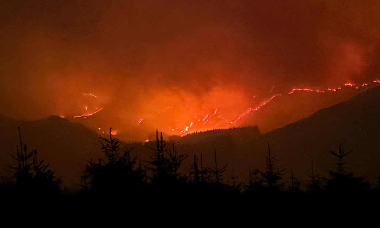 Wildfire on hills at night