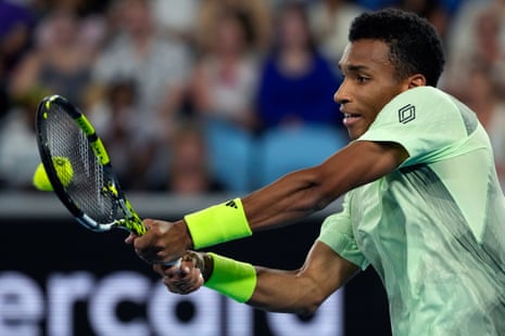 Felix Auger-Aliassime plays a backhand return to Dominic Thiem during their first round match at the 2024 Australian Open.