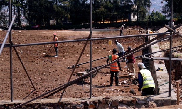 Construction workers building a basketball court next to the Hope hostel in Kigali