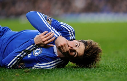Chelsea’s Fernando Torres puts his hand over his mouth after being hit in the face by an elbow from Liverpool’s Daniel Agger.