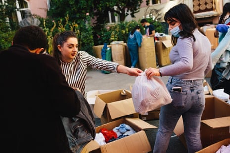 Volunteers sort through donated clothes