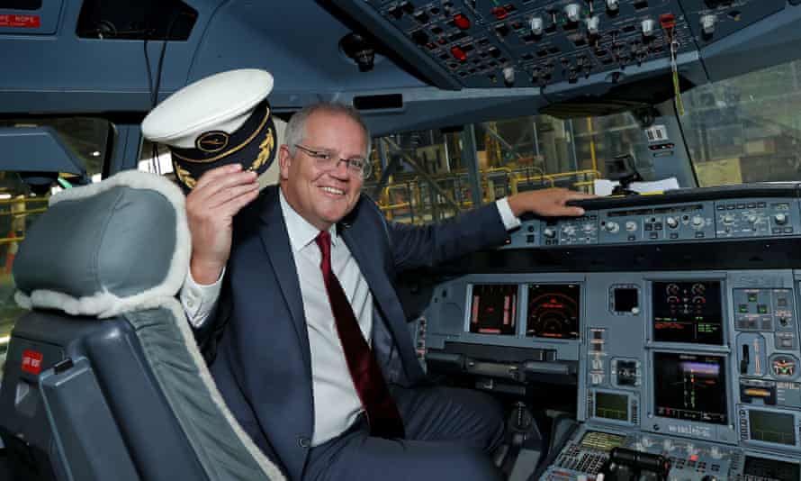 Prime Minister Scott Morrison poses for a photograph in the cockpit of an Airbus A330 at Qantas Hangar 96 during an aviation and tourism package announcement at Sydney Airport in Sydney, March 11, 2021.
