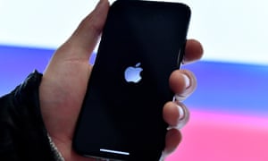 A person holds an iPhone