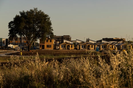 buildings behind grass